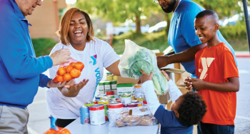 Our Mission YMCA members volunteering to donate food items